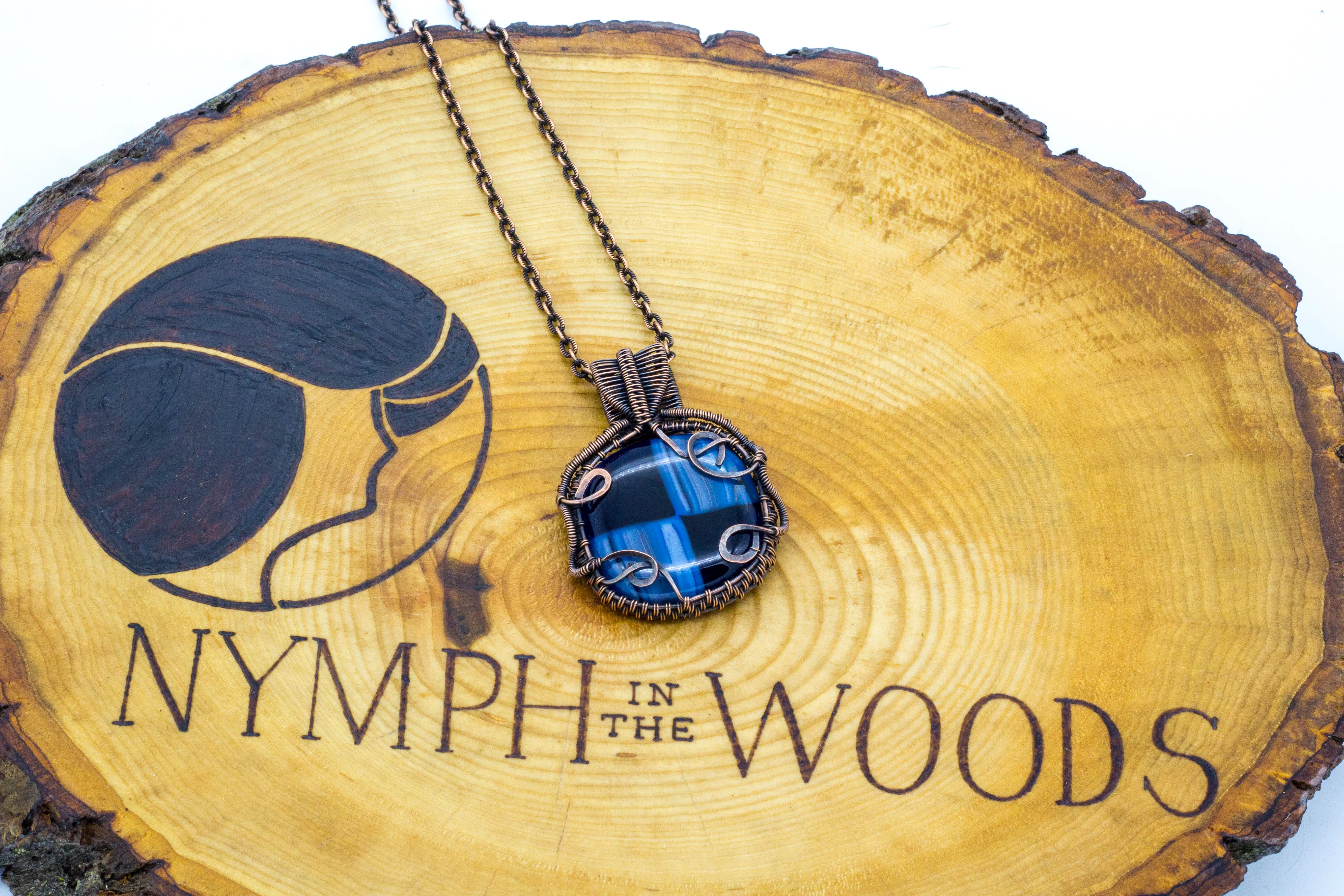 Reserved - Copper Wire Wrapped Pendant with Streaked Blue and Black Fused Glass